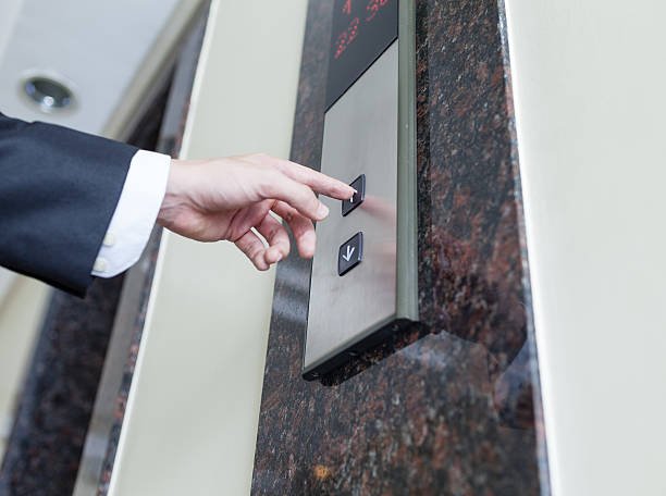 Close up of businessman pressing elevator button. battery backup for lift